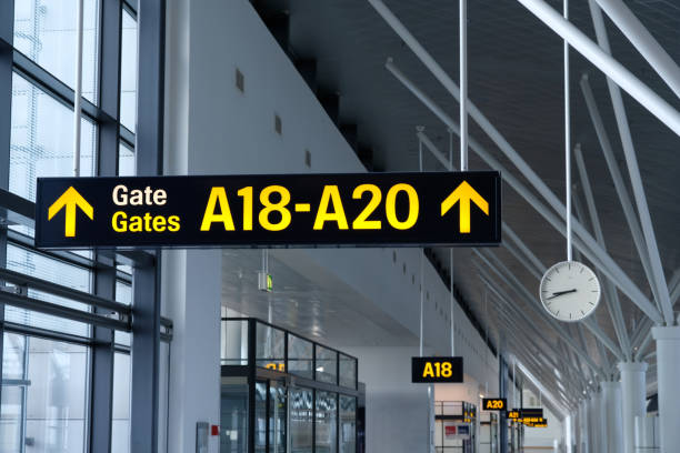 istock Airport terminal interior gate information sign shows way direction to gates 2179743898