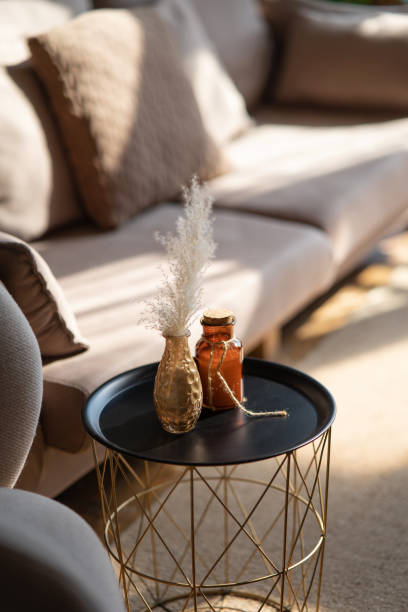 A serene living room scene featuring a couch and decorative items on a table, with soft lighting enhancing comfort