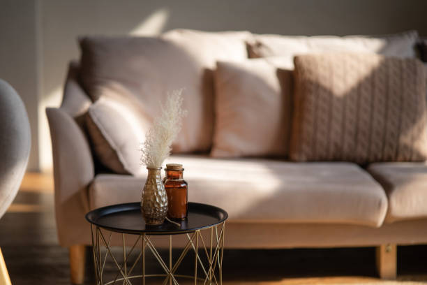 istock A serene living room scene featuring a couch and decorative items on a table, with soft lighting enhancing comfort 2179748793