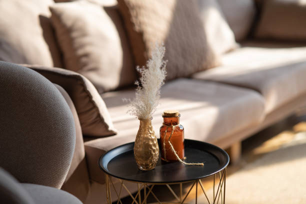 istock A serene living room scene featuring a couch and decorative items on a table, with soft lighting enhancing comfort 2179749064