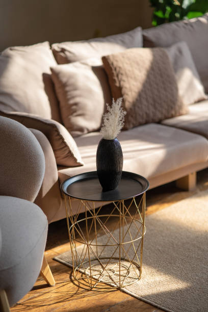 istock A serene living room scene featuring a couch and decorative items on a table, with soft lighting enhancing comfort 2179749080