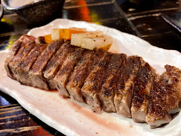istock Close up of medium rare A5 steak on white plate. 2179750851