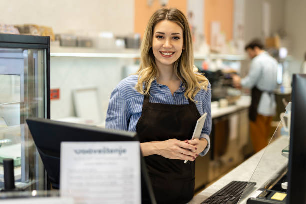 istock Smiling young baker at the checkout counter. 2179752171