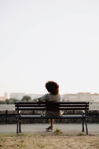 istock Unrecognizable afro woman sitting on park bench and resting 2179755735