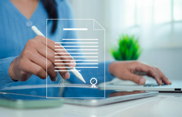 istock Businesswoman use electronic pen sign signature on electronic E-signing, Data sheet document management, Electronic signature and paperless office concept. 2179757967