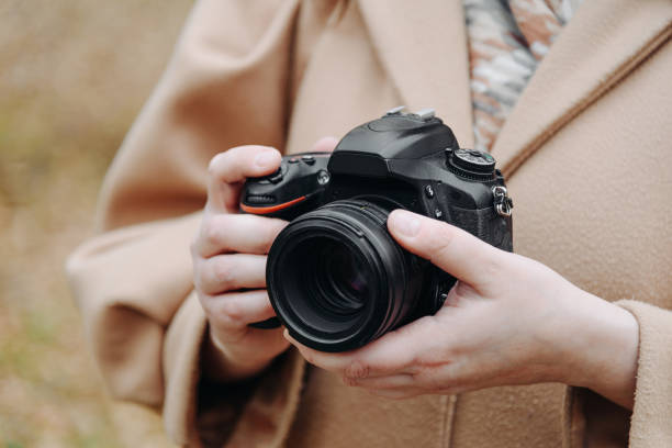 dslr camera in woman hands