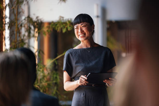 istock Smiling Speaker Leading a Business Conference or Lecture Session 2179758917