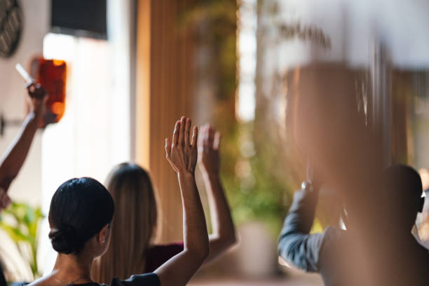 istock Engaged Audience Members Raising Hands During Business Conference 2179758919