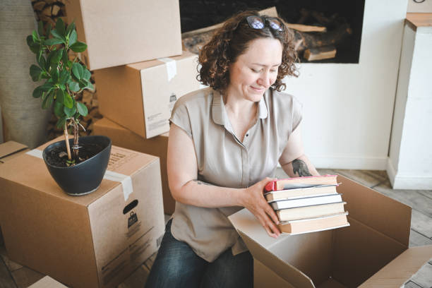 istock Mature woman with Moving Boxes in New Home 2179761929