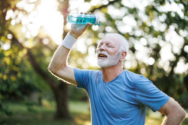 istock Tired senior man refreshing himself with water in nature 2179765008