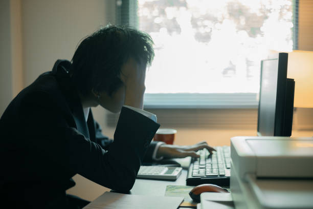 Stressed businessman, sleepy man working in his office, sat at his computer, feeling weight of his job and the demands of his business. person, work, business, stressed, sleepy, office, computer, job.