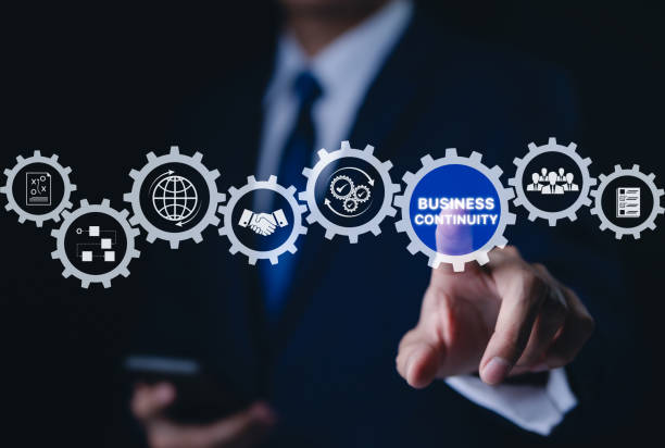 istock Business continuity concept. Businessman interact with gear featuring business continuity icons. strategies for maintaining operations during disruptions. minimizing financial losses, Risk management, 2179769222