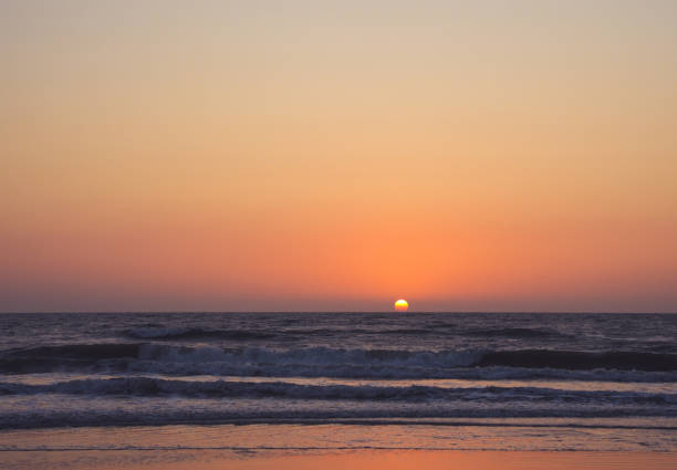 The sunset touches the sea horizon. Relaxation