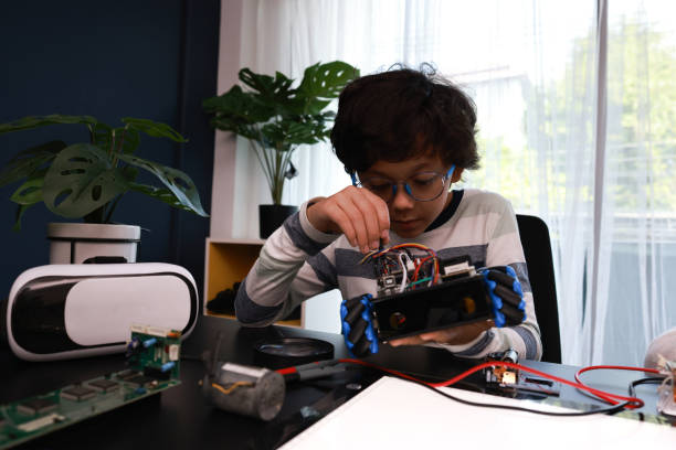 istock The enthusiastic schoolboy and schoolgirl are confidently engaged in constructing robots in the laboratory. 2179774433