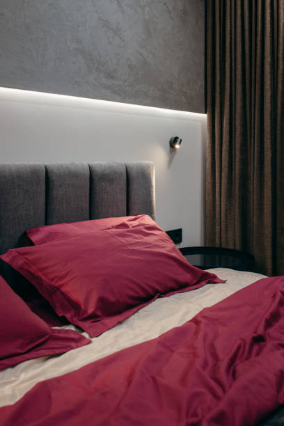 istock Red bedding on bed in bedroom 2179780370