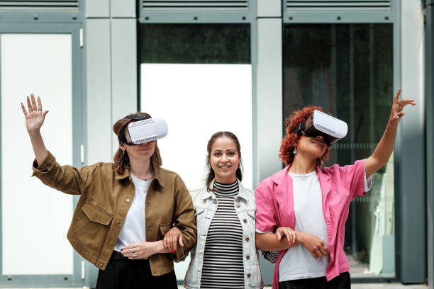istock Three young women experiencing virtual reality with headset outdoors 2179786868