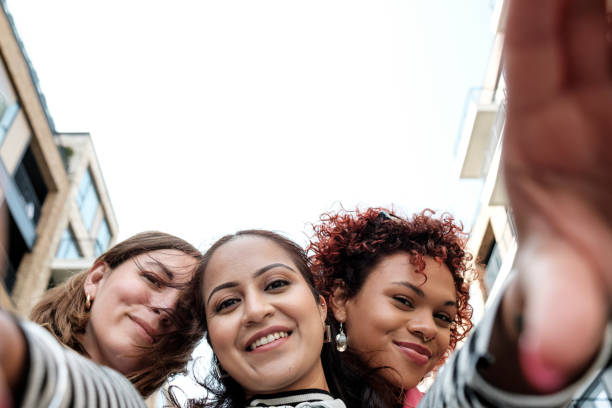 Three young women taking a selfie in the city