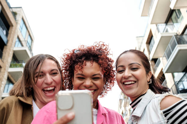 istock Three young women taking a selfie while walking in the city 2179786904