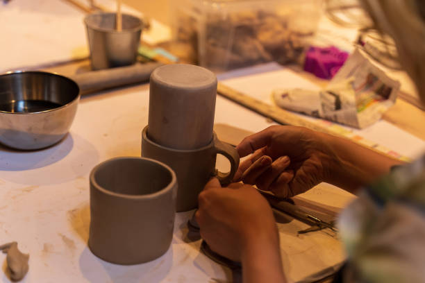istock Close-Up of Hands Shaping Clay Cups During Pottery Workshop 2179793142