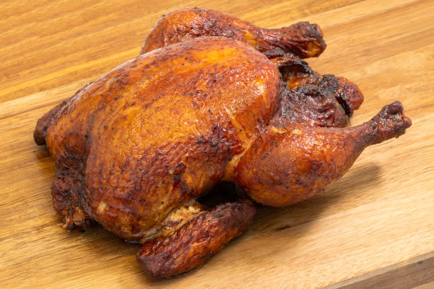 istock Hot Smoked Roasted Whole Chicken Served on a Rustic Wooden Cutting Board 2179794423