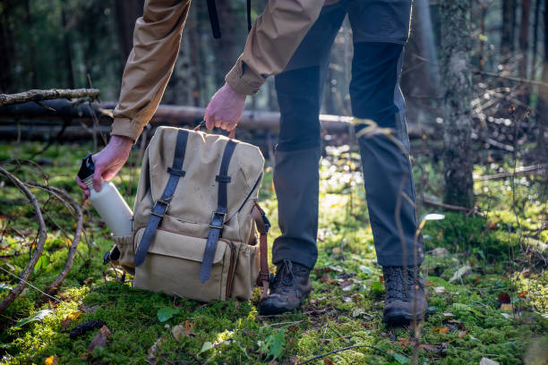 istock Man with a backpack and a bottle of water in the forest. 2179800449