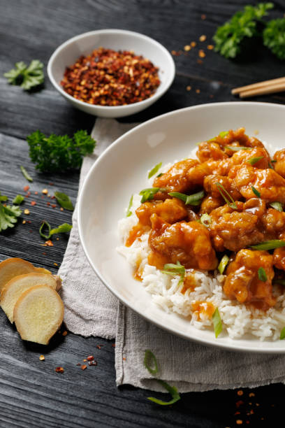 istock Chinese orange chicken with rice and green onion garnish 2179805852