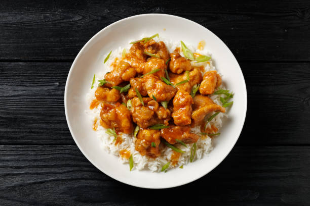 istock Chinese orange chicken with rice and green onion garnish 2179805853