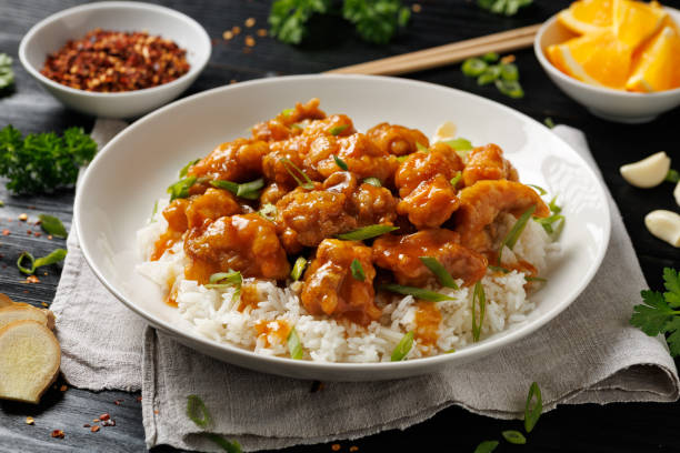 istock Chinese orange chicken with rice and green onion garnish 2179805856