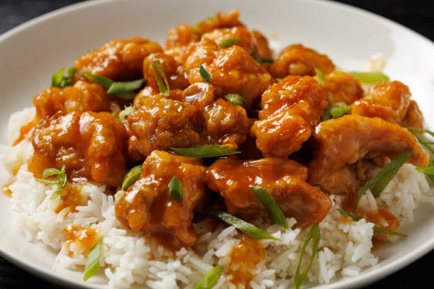 istock Chinese orange chicken with rice and green onion garnish 2179805985