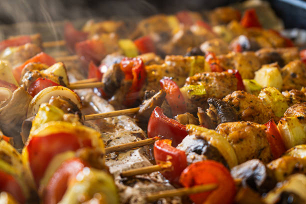 Closeup photo of fresh and delicious grilled chicken skewers covered with spices and seasonig with mushrooms, onions, paprika, zucchini. Ideals as grill snack or party food.
