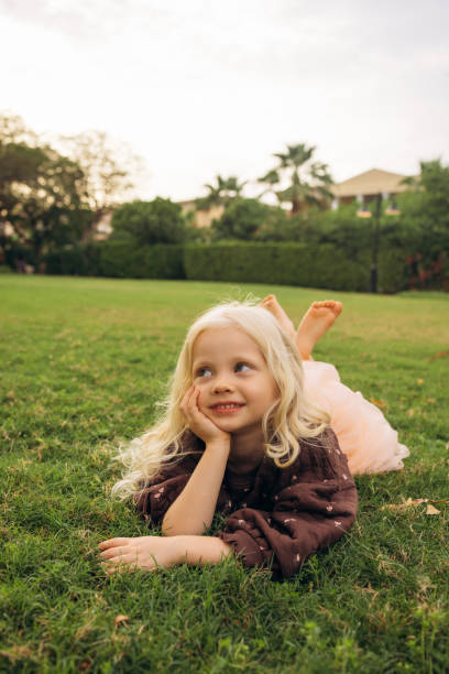 istock Contented Girl Resting on Grass 2179809325