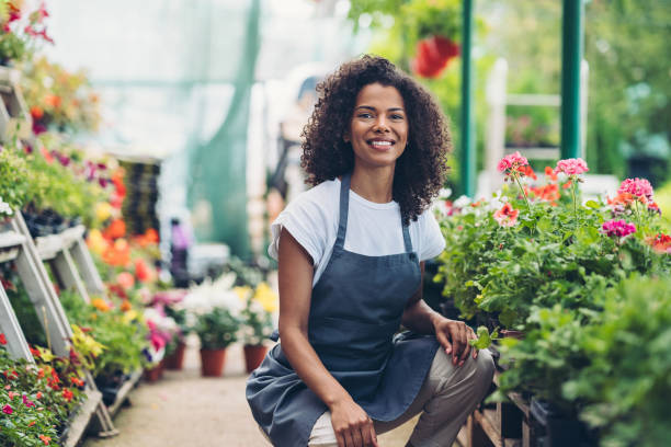 istock Cheerful young gardener with flowering plants 2179813306