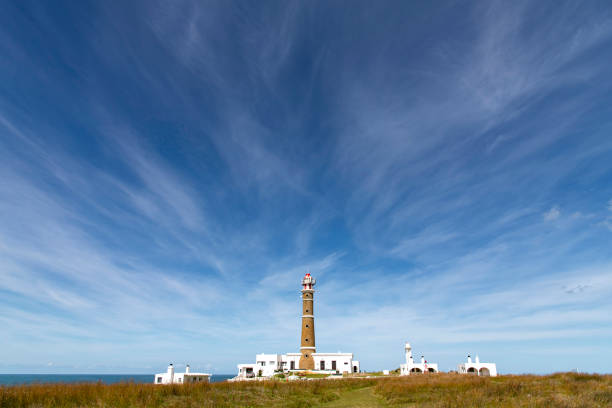Cabo Polonio, Uruguay-March 27, 2024; Cloudscape with the Cabo Polonio lighthouse along the rocky coastline of the settlement Cabo Polonio