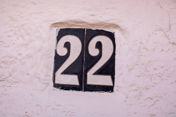istock Beautiful house number 22 in Spanish style. House number on a ceramic patterned base in the old town in Spain. Traditional Spanish patterned decoration of a plate with an apartment or house number 2179814466