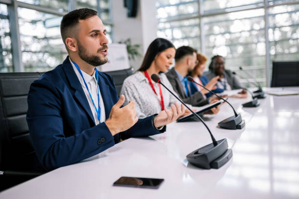 istock Man CEO talking on the microphone on meeting with his colleagues about business plan, future collaboration. 2179814687