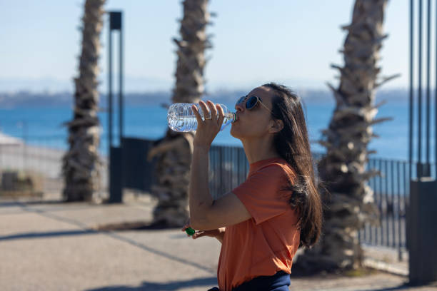istock woman drinking water 2179815787