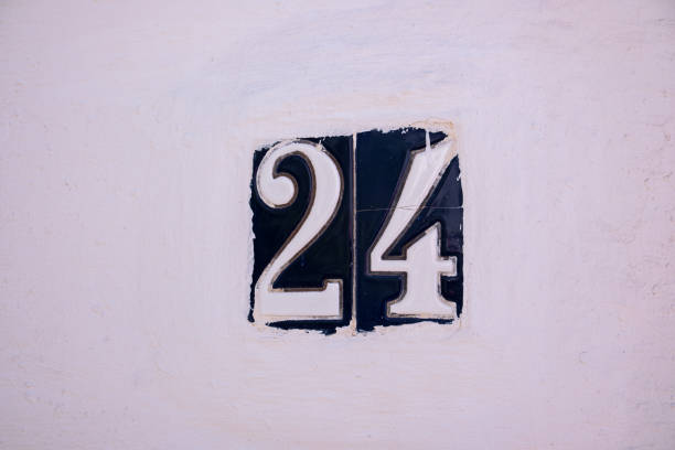 istock Beautiful house number 24 in Spanish style. House number on a ceramic patterned base in the old town in Spain. Traditional Spanish patterned decoration of a plate with an apartment or house number 2179817703