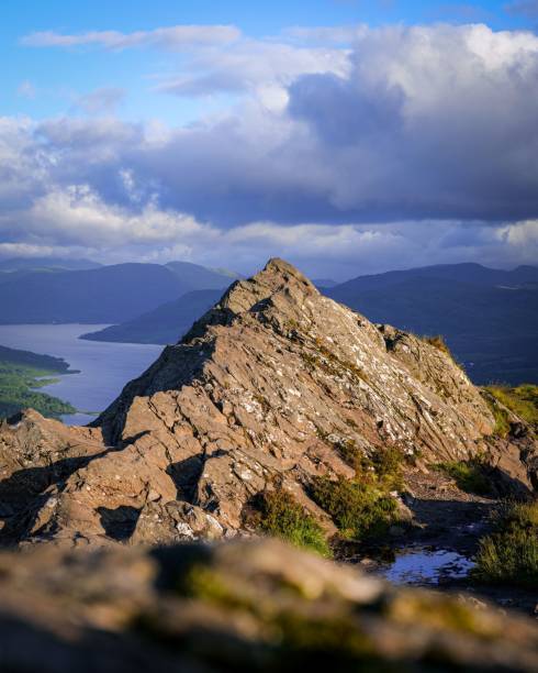 istock Rocky peak with lake view and dramatic sky. 2179820192