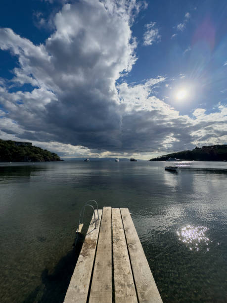 istock a pier on the shore in a small town 2179820642