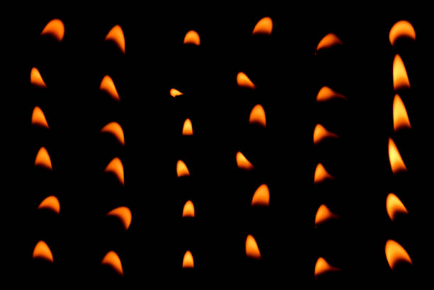 A close-up of intense yellow flames dancing on a BBQ grill, creating a captivating visual effect. The reflective metal surface enhances the fiery glow, evoking a sense of heat and energy. The image captures the essence of outdoor grilling and barbecue preparation, making it perfect for themes of culinary arts, summer gatherings, and food events. The fiery movement and vibrant colors add a dramatic and artistic flair.