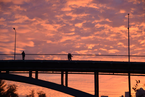 istock People on the bridge in sunset time 2179827531