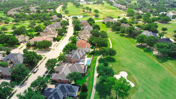 istock Master planned country club community with upscale residential housing development built around grassy golf course with pond and sand trap bunkers, fairways in Dallas Fort Worth metroplex, aerial 2179828219