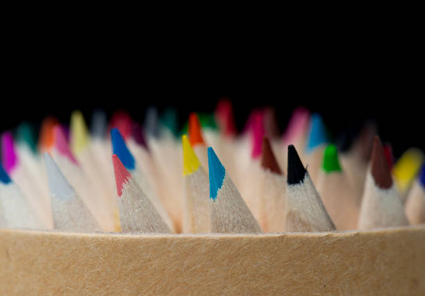 A macro shot of sharpened colored pencils, showcasing their vibrant tips against a dark background. This image symbolizes creativity, art, and expression, perfect for themes related to education, design, inspiration, and artistic work.