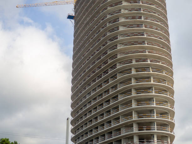 Construction of a high-rise building. Concrete structure. Construction business. Round house. Crane over the construction site