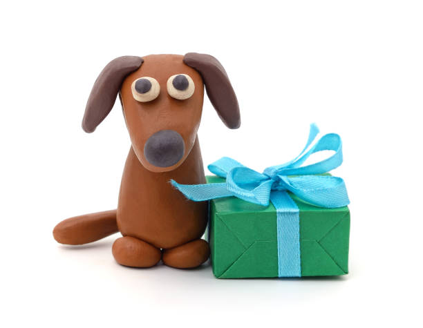 istock Plasticine puppy and green gift. 2179835232