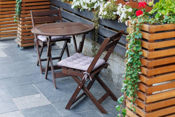 istock Outdoor cafe. An empty table and brown chairs stand on the sidewalk. 2179835585