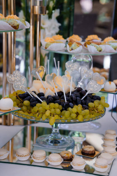 istock Exquisite Dessert Display Featuring Luscious Grapes, Elegant Macarons, and Decorative Lollipops 2179835753