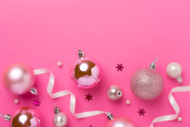 istock Pink christmas balls with decor on color background, top view 2179837841