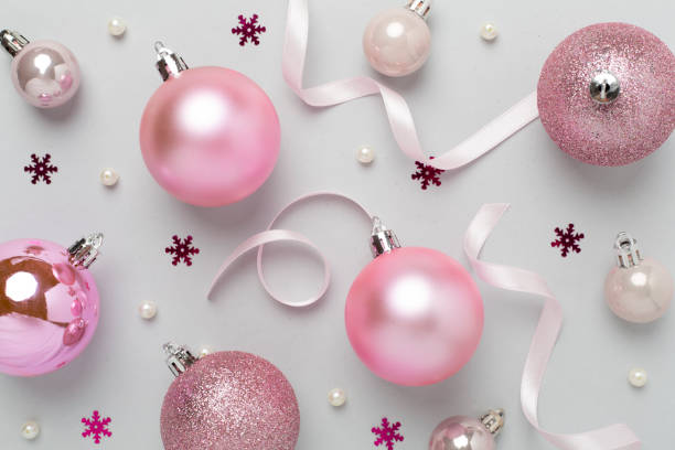 istock Pink christmas balls with decor on color background, top view 2179837844