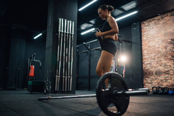 istock Athletic woman preparing for weightlifting training in a gym 2179850101